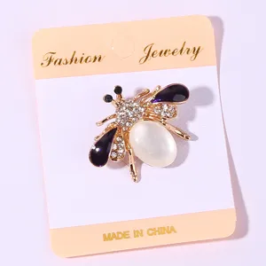 Elegant crystal bee brooch featuring pearl abdomen and enamel wings for women fashion accessory.