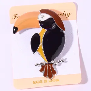 Cute cartoon toucan enamel brooch for women, creative fashion animal lapel pin jewelry detail.