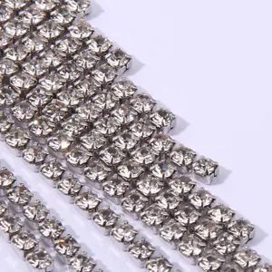 Close up detail of sparkling rhinestone tassel earrings, crystal fringe texture display.