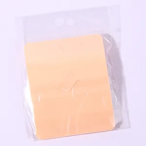 Detailed view of the blank backing card and transparent OPP packaging bag for jewelry items.