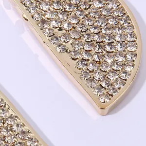 Close-up detail of golden rhinestone pave lemon slice earring pendant sparkling