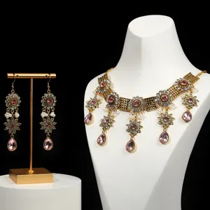 Detailed view of luxury vintage baroque crystal necklace and earrings set for evening party.