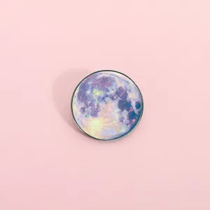 Round metal brooch badge featuring a colorful cosmic moon design on a sleek minimalist setting.