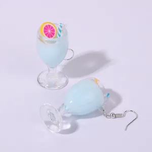 Miniature resin juice cup earring detail view, cute summer lemon and straw charm close-up shot.