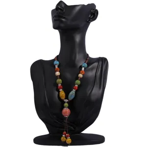 Detailed shot of retro ceramic bead necklace, long ethnic style sweater chain for linen clothes.