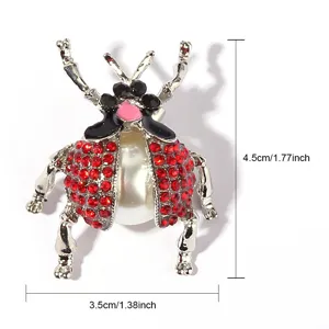 Exquisite retro beetle brooch featuring sparkling red rhinestones and a central pearl accent.