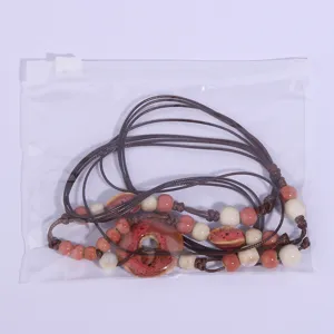 Detailed view of handmade ceramic bead sweater chain, vintage ethnic style long necklace accessory.