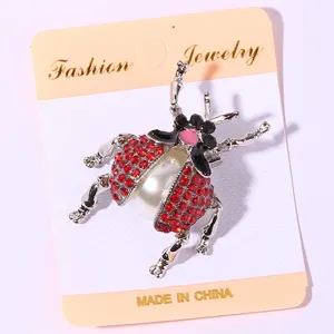 Cute rhinestone ladybug brooch pin with central pearl, fashion insect jewelry for women.