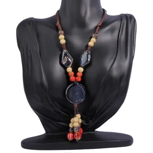 Detailed view of handmade ceramic pendant ethnic retro long sweater chain necklace with beads.