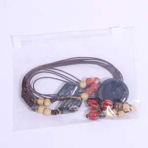 Detail view of handmade ceramic beaded pendant sweater chain, retro ethnic necklace accessory.
