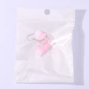 Cute mini milk tea cup drop earrings detailed close-up view in transparent bag for sale.