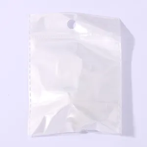 Transparent plastic packaging bag detail, clear ziplock bag with hanging hole for small items.