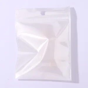 Clear plastic self-sealing packaging bag with hang hole, ideal for small items storage.
