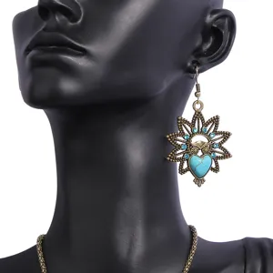 Vintage bronze owl turquoise drop earrings detail view, bohemian ethnic style jewelry closeup.