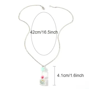 Silver tone chain necklace with a cute glass bottle dried flower pendant detail view
