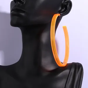 Oversized neon orange acrylic hoop earrings, bold statement jewelry for modern street style.