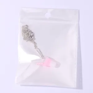 Close up detail of a cute pink mini drink cup pendant necklace with fine chain in clear bag.