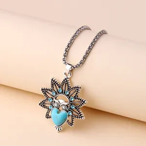 Detailed view of vintage owl pendant necklace with turquoise heart and blue crystals for women.