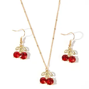 Gold-tone cherry necklace and earrings set featuring vibrant red crystal rhinestones.