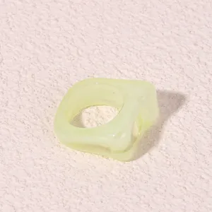 Close-up detail shot of a trendy geometric two-tone acrylic resin ring, minimalist design.