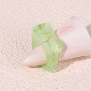 Close-up of a trendy translucent green acrylic geometric chunky ring for modern stylish women.