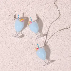 Detailed shot of cute 3D blue juice cup resin earrings and matching necklace jewelry set.