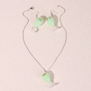 Cute resin kiwi juice cup necklace and earrings detail view, fashionable novelty jewelry set.
