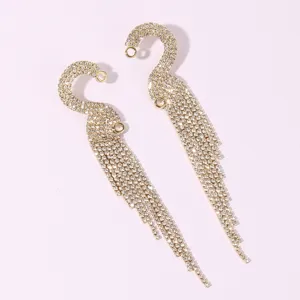 Detailed close-up of sparkling crystal rhinestone long tassel earrings with elegant curved design.