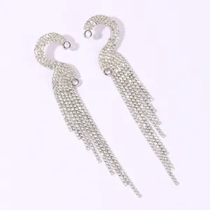 Detailed close-up of sparkling rhinestone tassel earrings, brilliant silver alloy dangling chain.