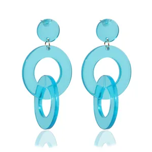 Close-up detail of bright blue acrylic geometric drop earrings with modern double circle design.