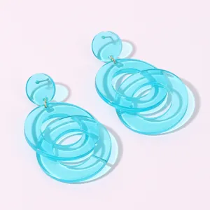 Close-up detail shot of translucent light blue acrylic geometric double circle drop earrings.