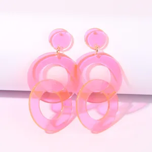 Pink acrylic geometric circle drop earrings detail shot, stylish summer resin ear jewelry.