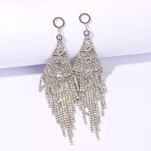Detail shot of silver rhinestone tassel earrings, sparkling geometric drop design for evening party.