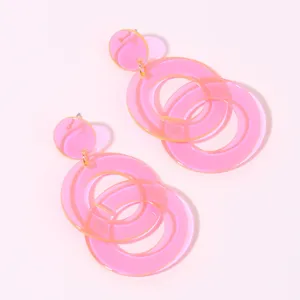 Pink translucent acrylic geometric circle earrings detail view, summer fashion drop earrings.