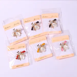 Detailed view of fashionable rhinestone bee brooch, cute insect design with pearl and crystal.