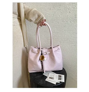 Pink woven leather tote bag for women, stylish shoulder bag with double top handles and charms.