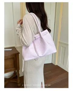 Stylish pink woven leather tote bag, large capacity shoulder bag for women daily commute.