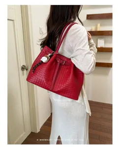 Spacious red woven leather tote bag for women, stylish commuting shoulder bag with chic design.