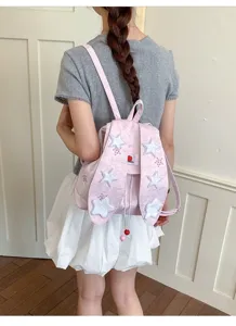 Detail shot of the pink canvas student backpack with star appliqués and cute flap design.