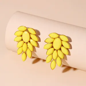 Detailed view of yellow cluster crystal statement earrings with gold-tone alloy setting.
