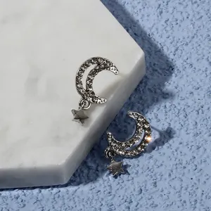 Silver crescent moon star stud earrings with sparkling rhinestones, elegant detail jewelry style.