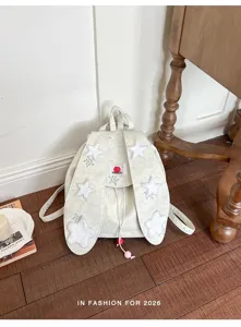Detailed view of the cute canvas backpack featuring bunny ears and star appliques for students.