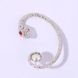 Detailed view of silver snake ear cuff with sparkling crystals and colorful rhinestone tail stone.
