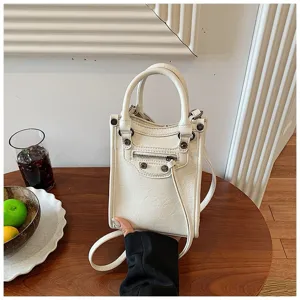 White mini handbag with studded design, stylish shoulder and crossbody bag for daily fashion.