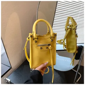 Mini yellow crossbody shoulder bag for women, stylish phone bag with zipper and metal studs.