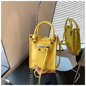 Yellow mini shoulder bag for women, stylish crossbody phone bag with metal studs and top handle.