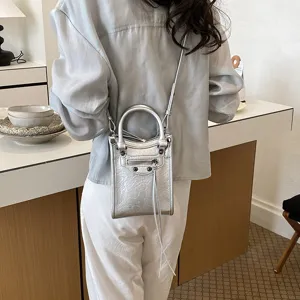 Silver metallic mini crossbody phone bag, vertical handbag with top handles and chic tassels.