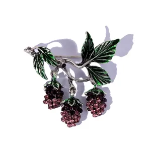 Vintage rhinestone berry brooch pin with green enamel leaves, elegant metallic plant jewelry.