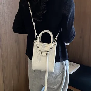 White vertical mini handbag crossbody phone bag with zipper studs for women detail view