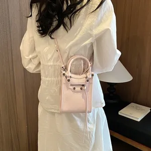 Stylish pink mini crossbody handbag for women, chic PU leather shoulder bag with zipper and studs.